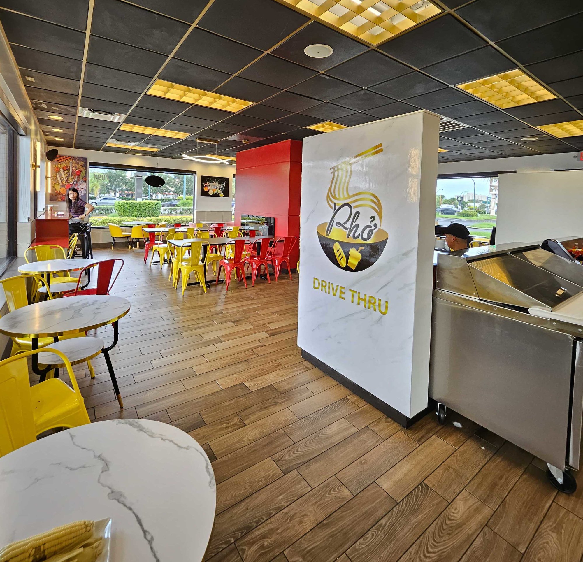 inside of pho drive thru with yellow chairs and accents